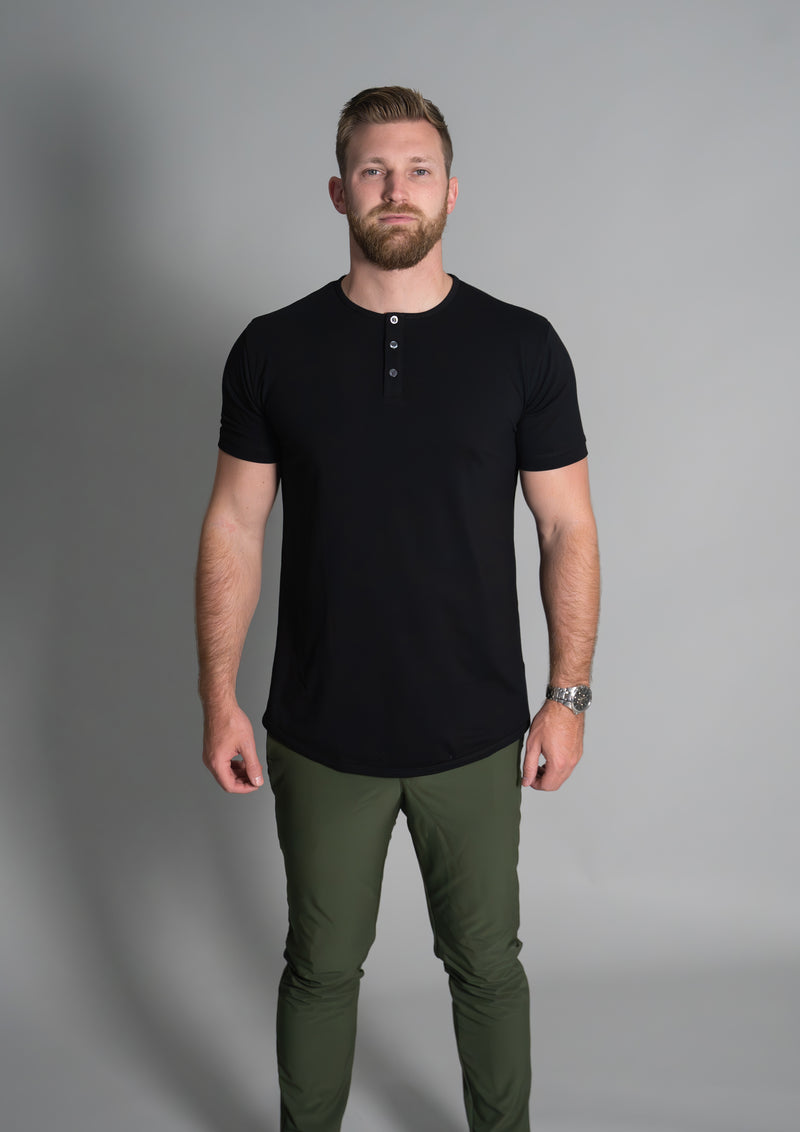 Front facing view of male model in black crew neck henley shirt from ten10 apparel