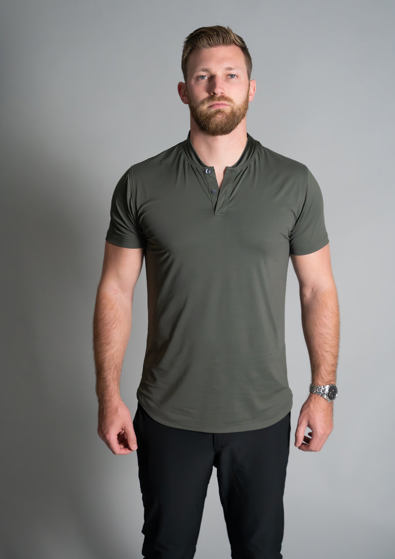 Male model facing directly into camera in men's forest green ares mock neck polo from 10 apparel