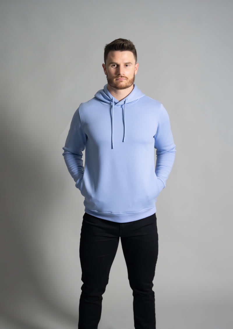 Male model with hands in pocket facing forward in mist light blue cortex mens hoodie