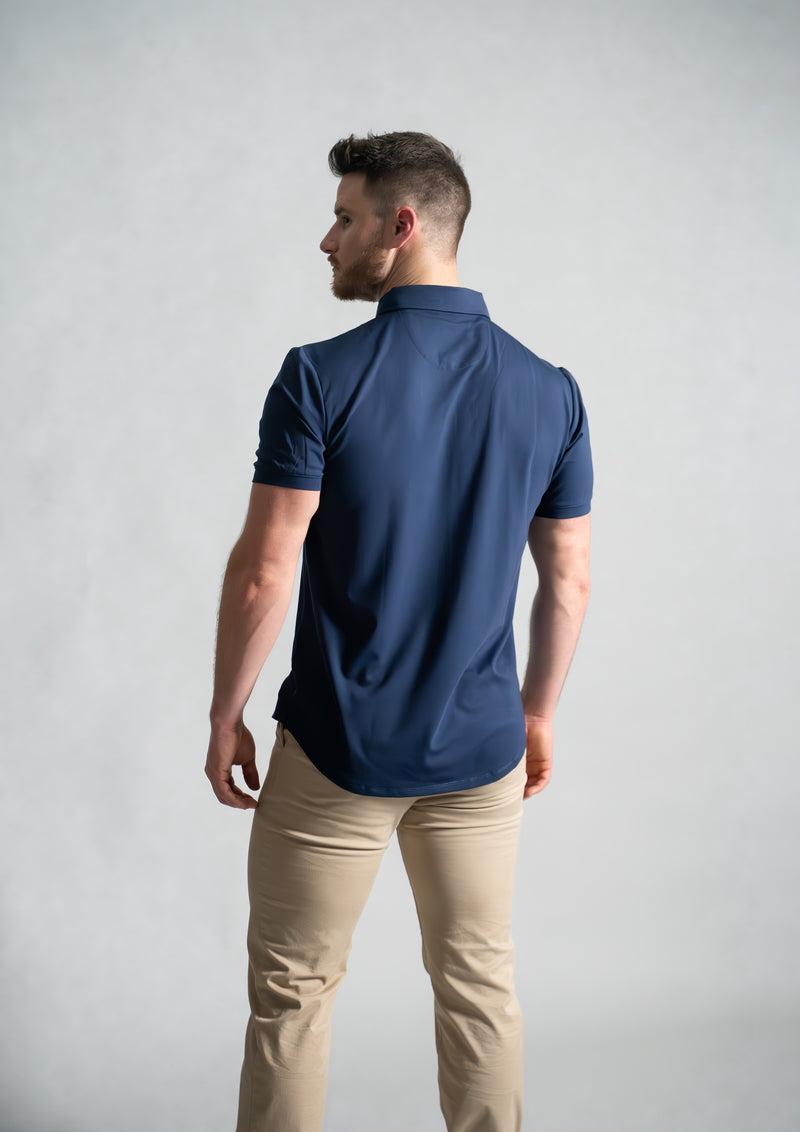 dark blue polo with model focusing on the back view from ten10 apparel