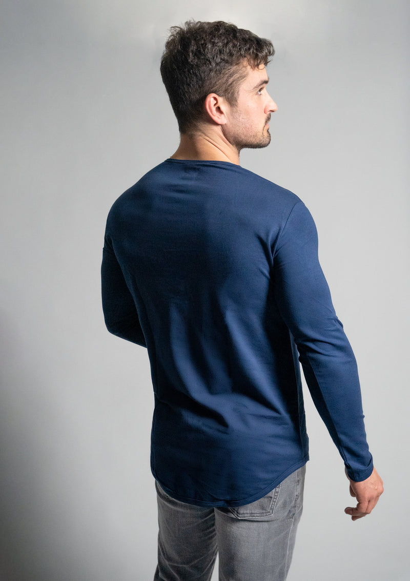 Oxford blue long sleeve from Ten10 apparel, with male model with back facing the camera