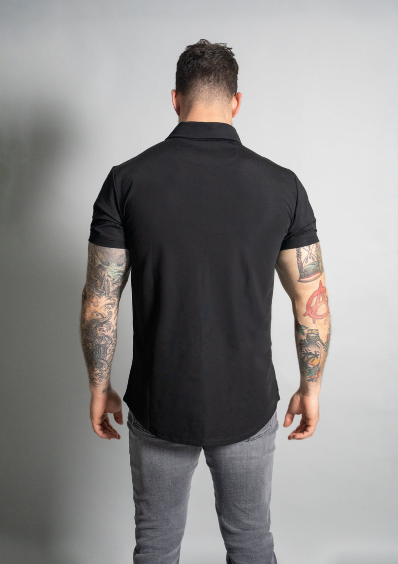 picture of model in a premium polo with back towards the viewer