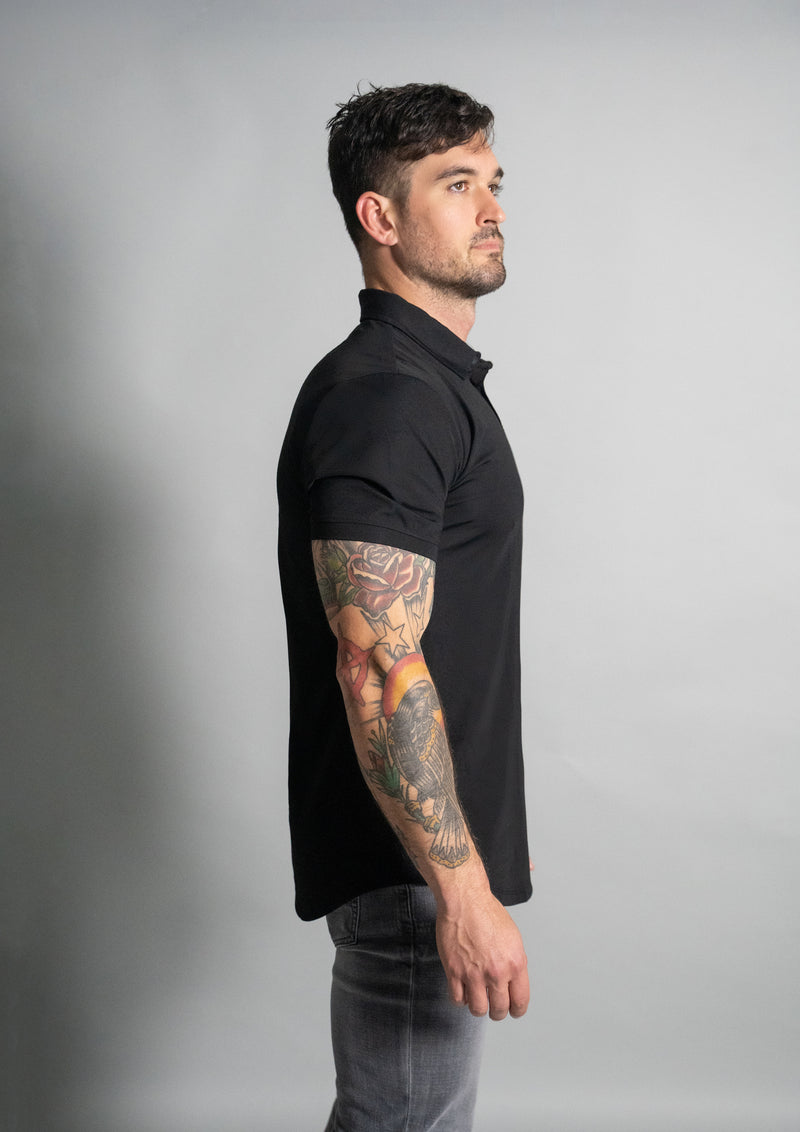 Side profile view of male model in a premium black polo from ten 10 apparel
