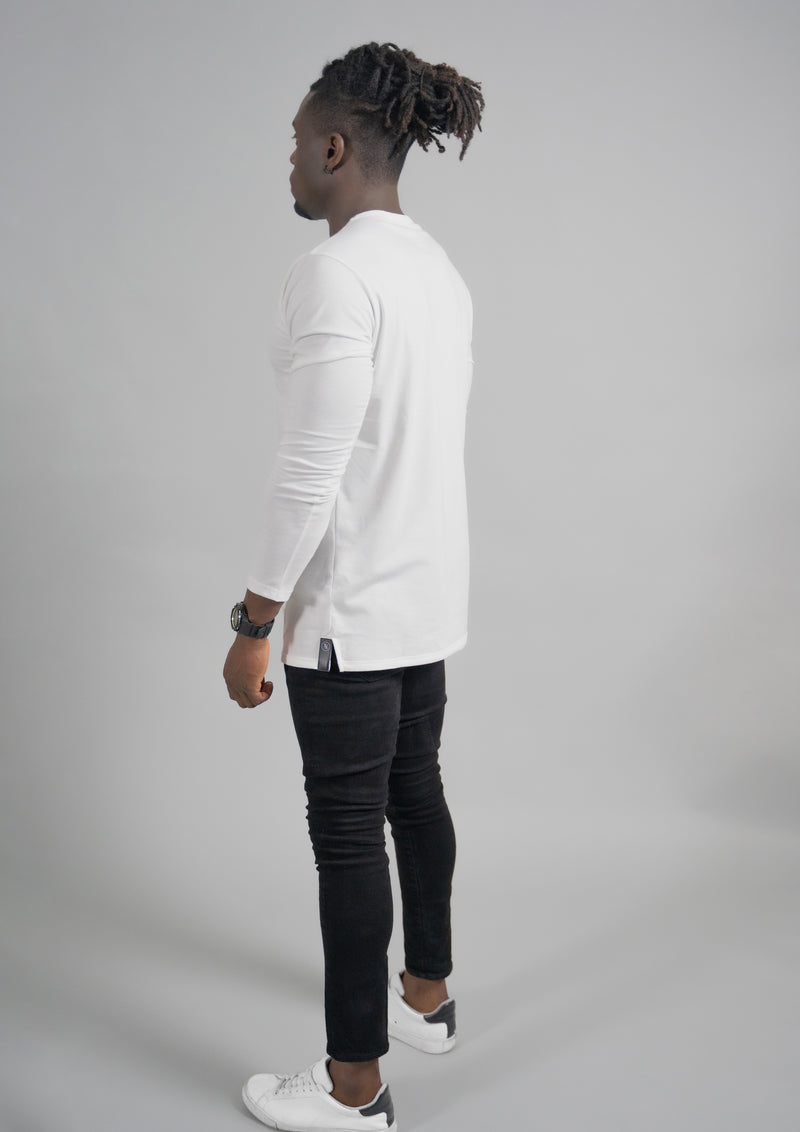 Person in a white long sleeve split hem by 1010 clothing facing away from the camera with a full body view in the L/S Shirt