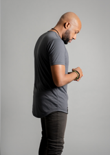 right side view of male model in a charcoal shirt from ten10 apparel