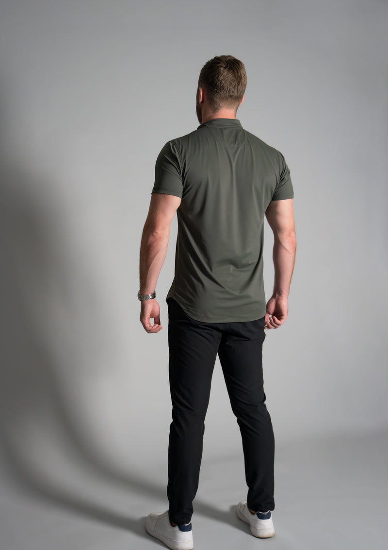 Model with back turned to camera in a Forest green Ares Polo from Ten10 apparel