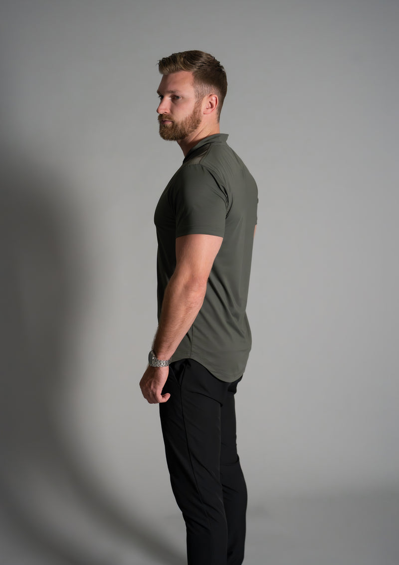 Male model in dark forest green Ares mock neck polo from 10 10 apparel