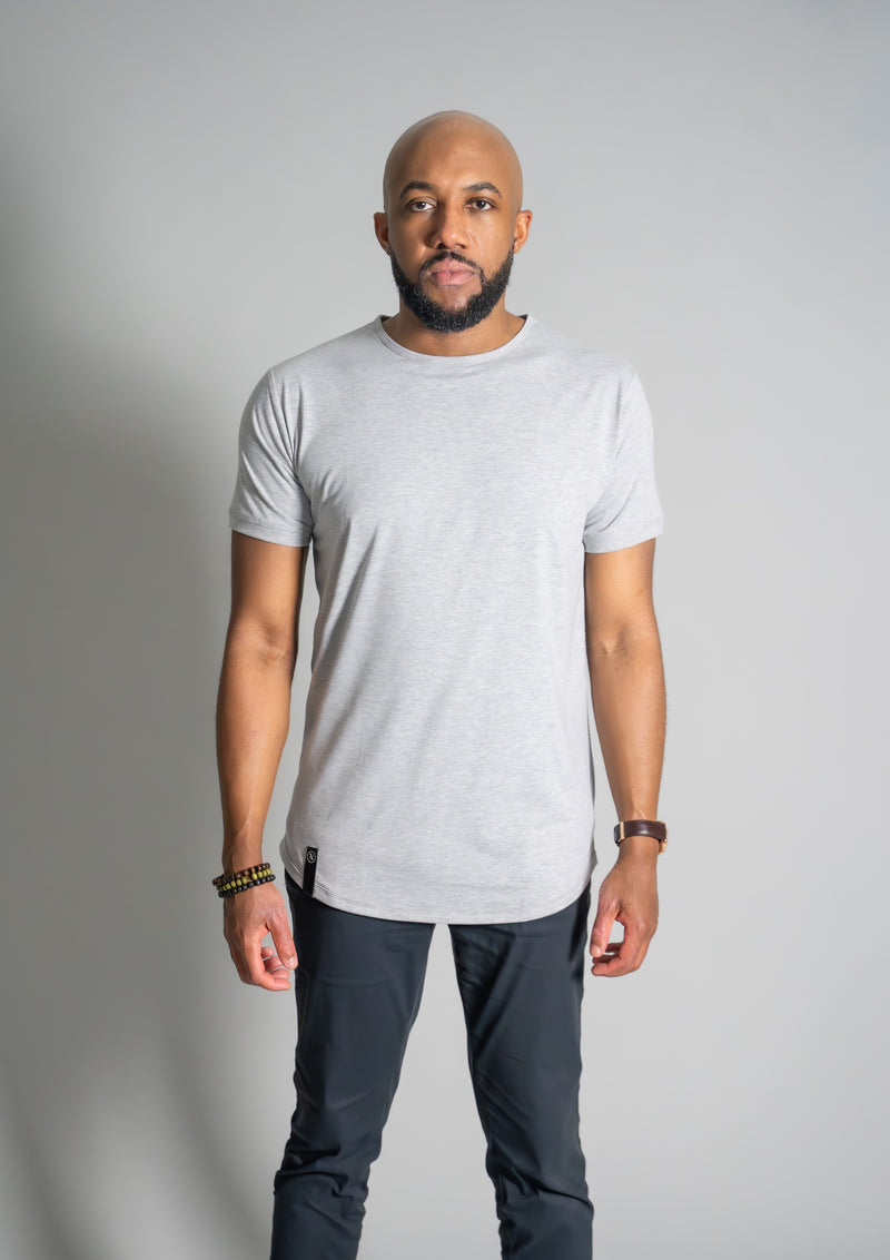 Model in a crew neck heather grey curved hem tee from ten10 apparel