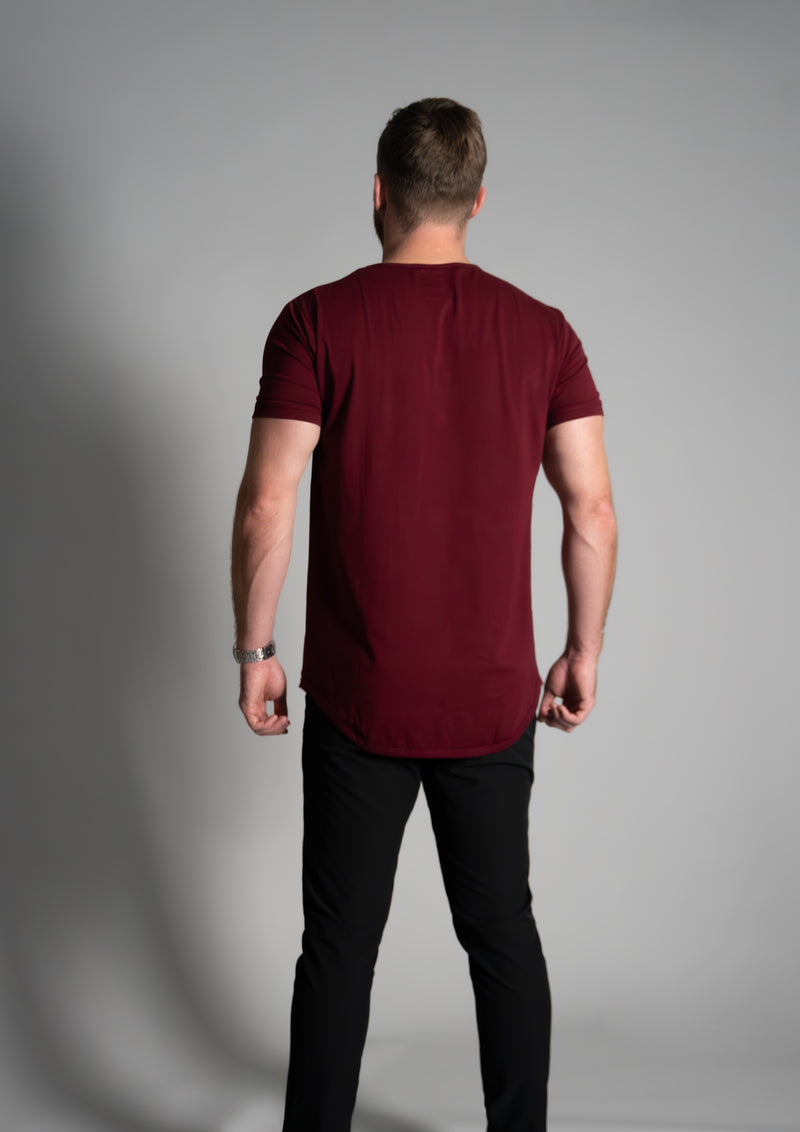 Athletic model in red curved hem tee with showing back