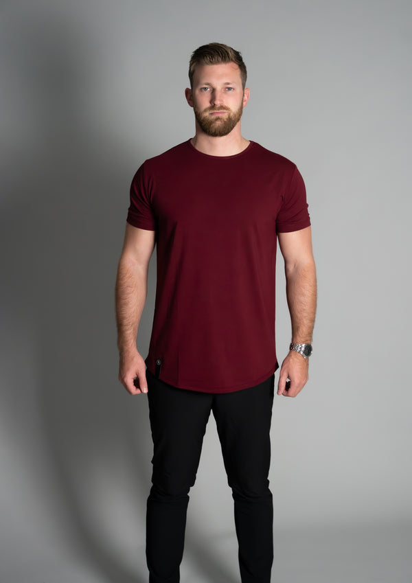 Male model in dark red curved hem shirt from 10 10 apparel
