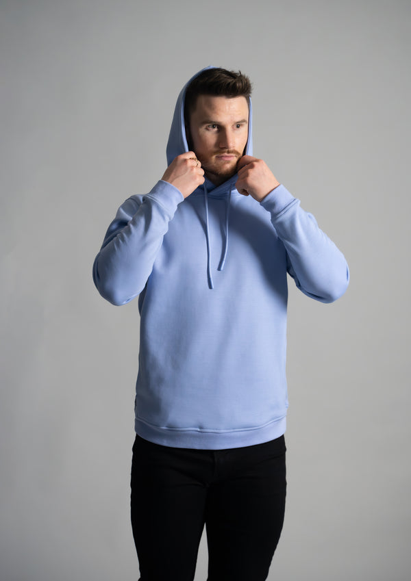 light blue hoodie with male model holding the hood from ten10 apparel
