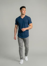 Man walking in a navy V-neck from ten10 apparel