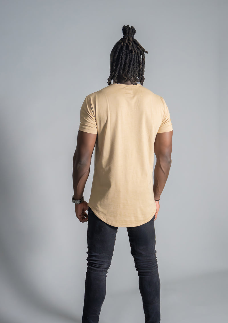 Male model in curved hem beige henley facing away from the camera
