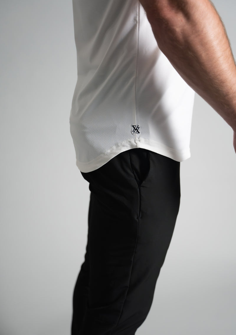 Close view of the ten10 apparel logo, on the white Ares polo