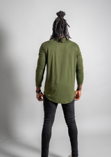 male model in a dark green long sleeve showing his back. Shirt from Ten/10 apparel