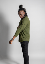 Male model pulling up sleeve of a Ten10 apparel Fern color long sleeve