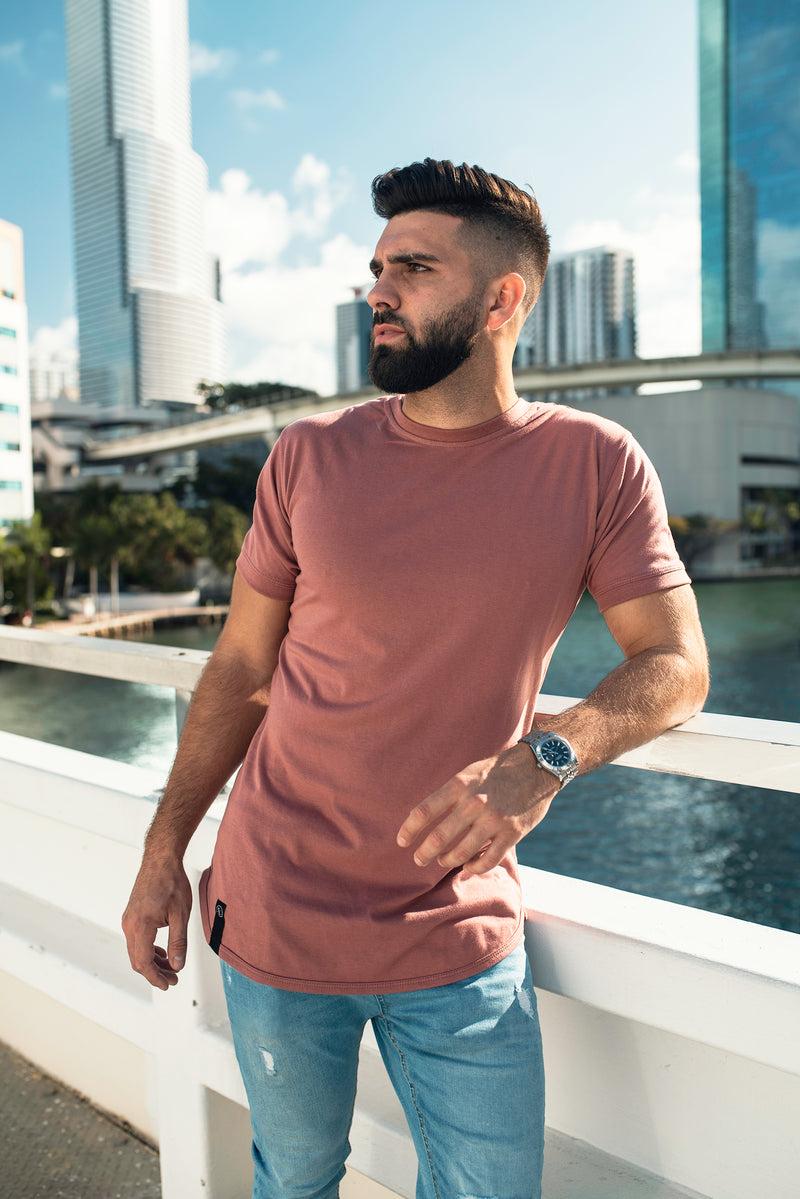 Male model in the Ten out of Ten Rosewood pink colored shirt gazing in to the distance while in downtown Miami Beach