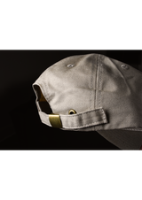 Moody dramatic picture of the back strap of the. desert oak colored free structured hat from Ten out of Ten apparel