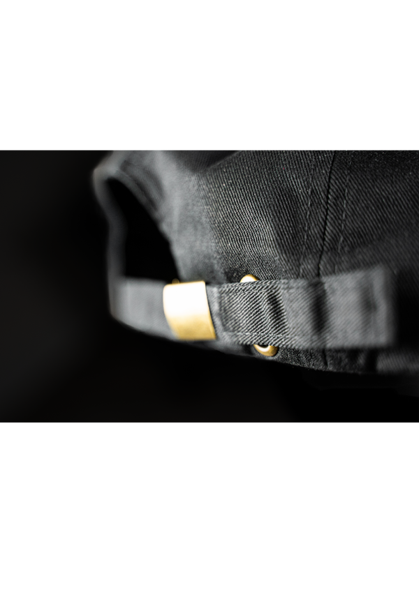 Moody dramatic picture of the back strap of the midnight black colored free structured hat from Ten out of Ten apparel
