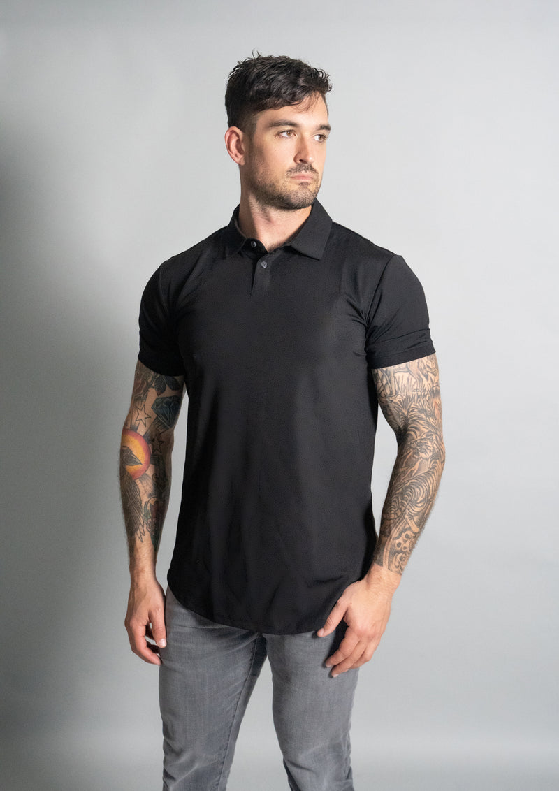 Black stratus polo from ten10 apparel with male model that has black hair staring to the right