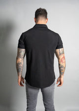 picture of model in a premium polo with back towards the viewer