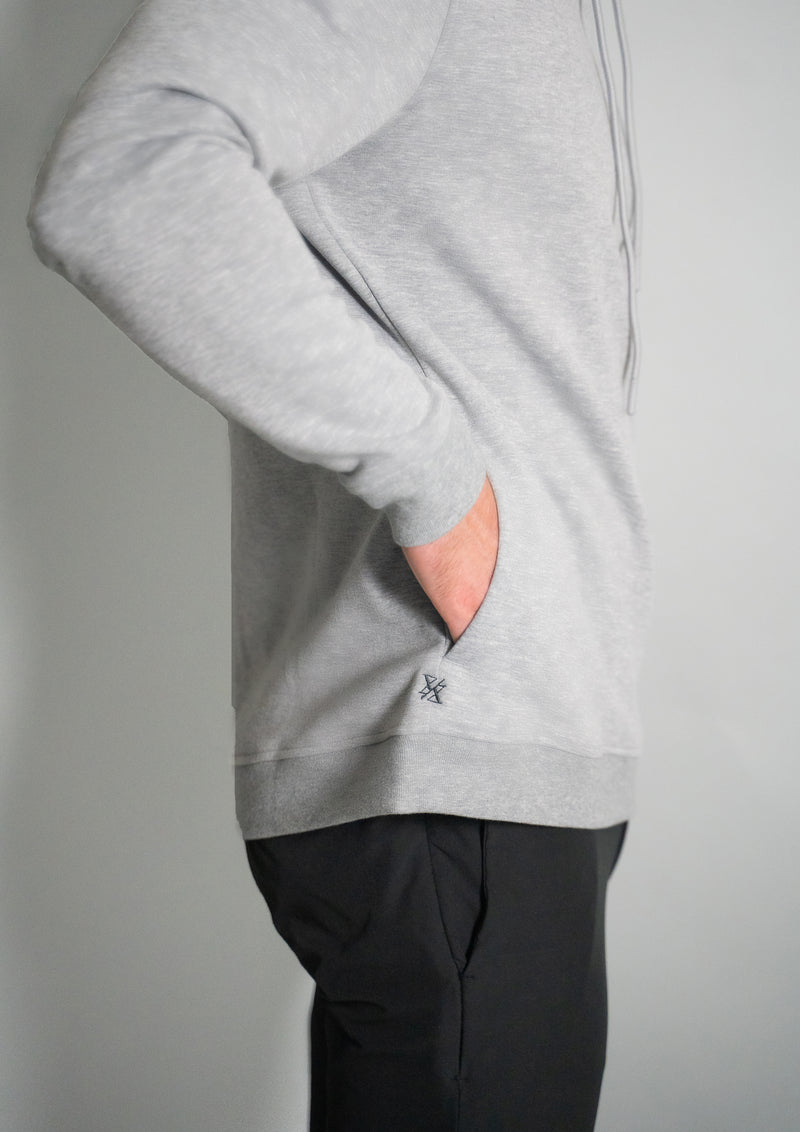 Hand in the pocket of the heather grey cortex hoodie from ten/10 apparel